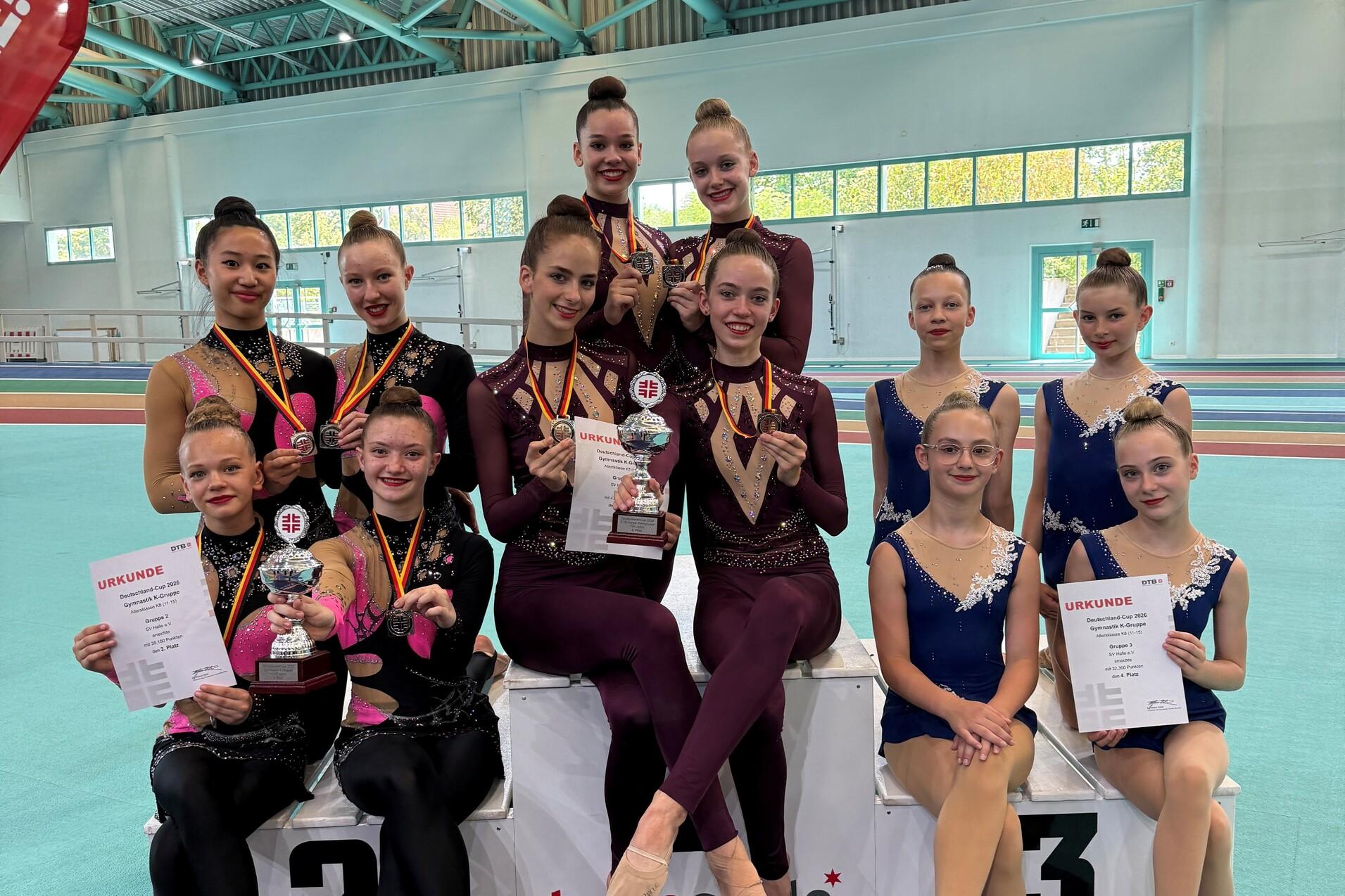 Die Gruppen des SV Halle auf dem Siegerpodest des Deutschland-Cups Gymnastik 2026 mit Medaillen, Pokalen und Urkunden